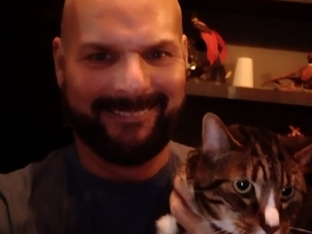 Paul Orr, head client care assistant, holding a cat